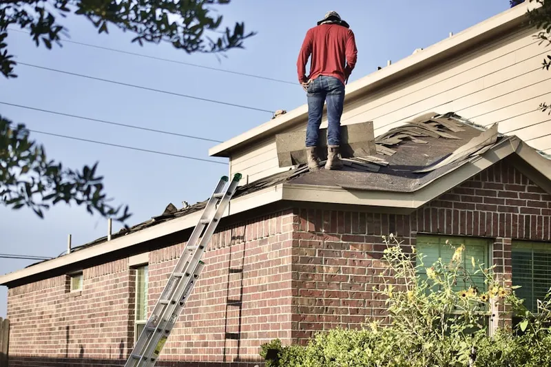 Professional roofer working on a residential roof in Meadow Park
